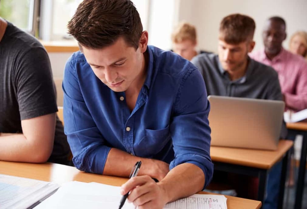 An adult man studying at an English lesson