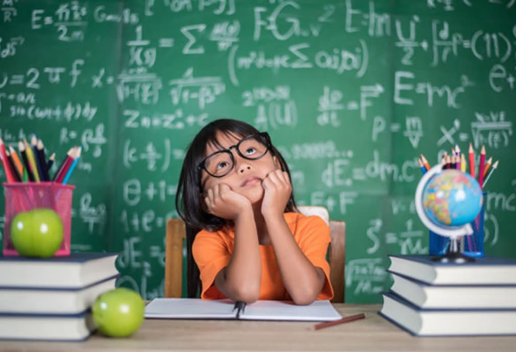 Girl with blackboard with formulas on the background